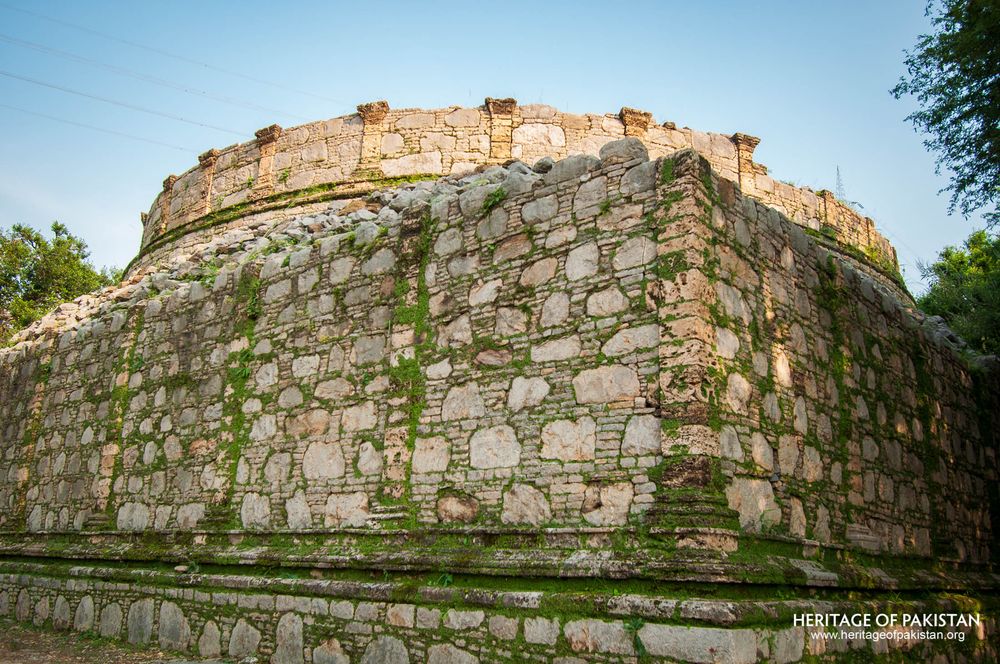 Weathered stone surface displays characteristic moss growth patterns.